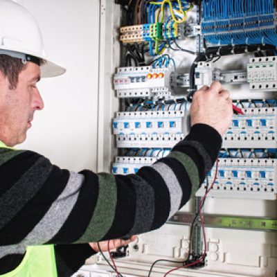 Electrician checking a fuse box